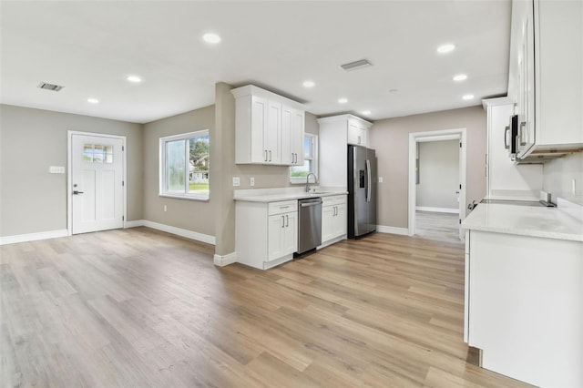 1110 Canal St, Ruskin, FL 33570 - kitchen featuring appliances with stainless steel finishes, recessed lighting, light countertops, light wood finished floors, and baseboards