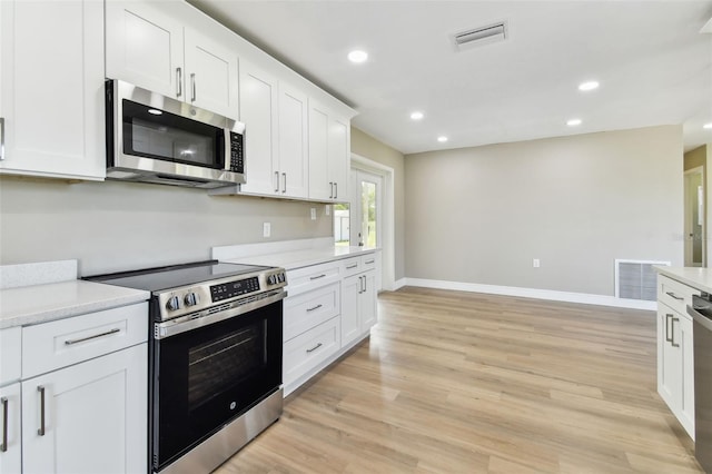 1110 Canal St, Ruskin, FL 33570 - kitchen featuring appliances with stainless steel finishes, baseboards, light countertops, white cabinetry, and recessed lighting