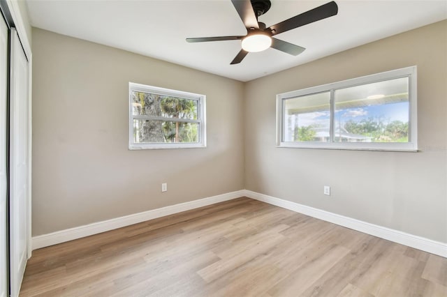1110 Canal St, Ruskin, FL 33570 - empty room featuring healthy amount of natural light, light wood-style flooring, baseboards, and a ceiling fan