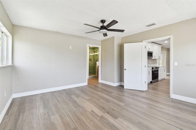 1110 Canal St, Ruskin, FL 33570 - empty room featuring light wood finished floors, baseboards, and ceiling fan