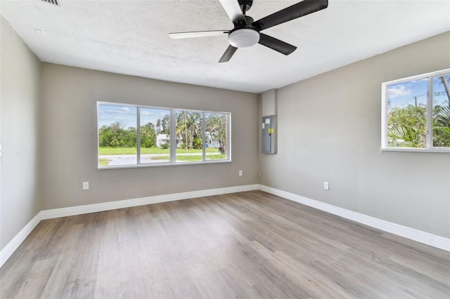 1110 Canal St, Ruskin, FL 33570 - spare room with wood finished floors, baseboards, a ceiling fan, and electric panel