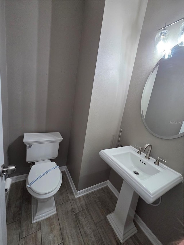 1521 Sourwood Dr, Ocoee, FL 34761 - half bath featuring toilet, wood finished floors, and baseboards