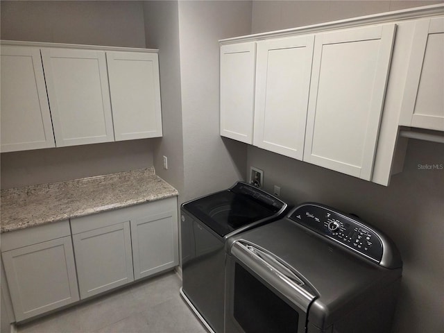 1521 Sourwood Dr, Ocoee, FL 34761 - washroom with washing machine and dryer, cabinet space, and light tile patterned floors