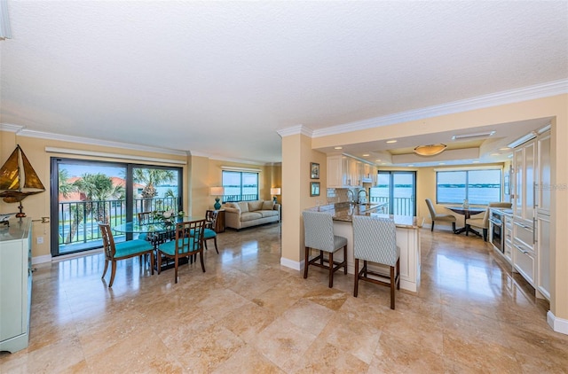 240 Sand Key Estates Dr Unit 222, Clearwater, FL 33767 - dining area with crown molding, plenty of natural light, baseboards, and a textured ceiling