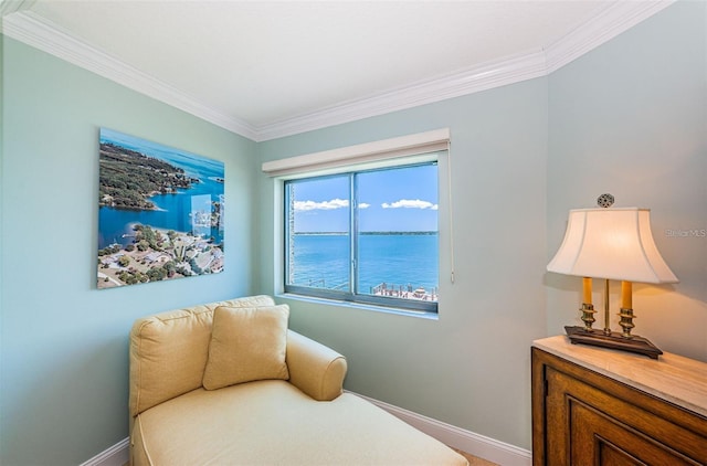 240 Sand Key Estates Dr Unit 222, Clearwater, FL 33767 - living area featuring ornamental molding, baseboards, and a water view