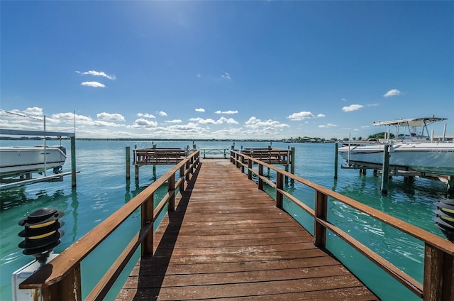 240 Sand Key Estates Dr Unit 222, Clearwater, FL 33767 - dock featuring boat lift and a water view