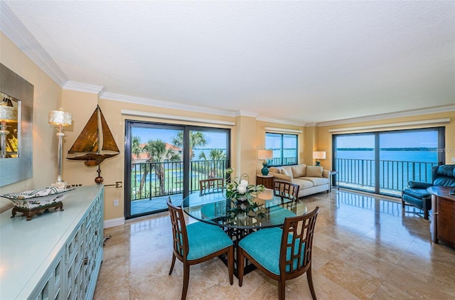 240 Sand Key Estates Dr Unit 222, Clearwater, FL 33767 - dining area featuring crown molding, baseboards, and a textured ceiling