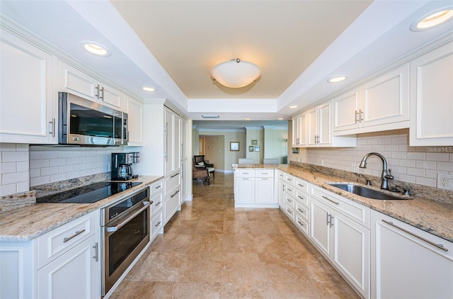 240 Sand Key Estates Dr Unit 222, Clearwater, FL 33767 - kitchen featuring stainless steel appliances, a sink, white cabinets, and recessed lighting