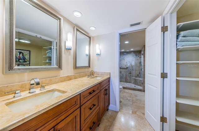 240 Sand Key Estates Dr Unit 222, Clearwater, FL 33767 - bathroom featuring a shower stall, double vanity, toilet, recessed lighting, and tile patterned flooring