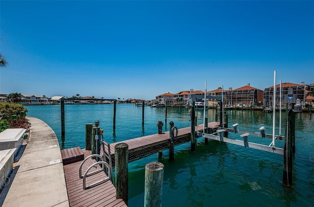240 Sand Key Estates Dr Unit 222, Clearwater, FL 33767 - dock featuring a water view, a residential view, and boat lift