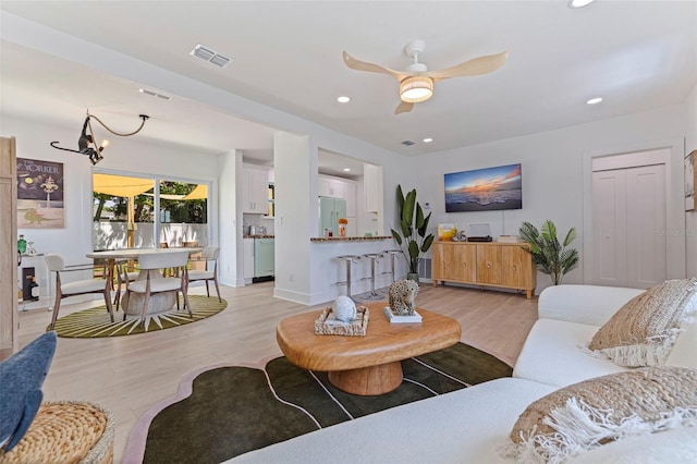1579 Bayshore Blvd, Dunedin, FL 34698 - living area with light wood-type flooring, a ceiling fan, recessed lighting, a chandelier, and baseboards