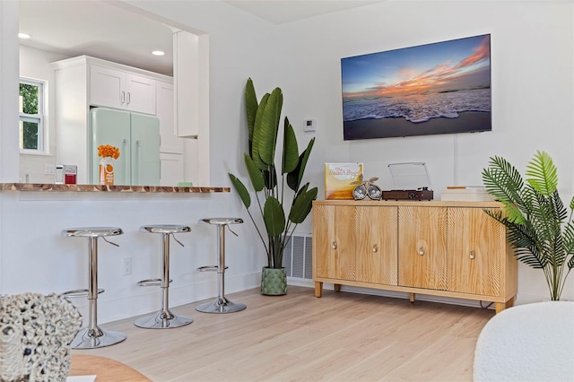 1579 Bayshore Blvd, Dunedin, FL 34698 - kitchen featuring white refrigerator, light wood-style floors, white cabinetry, recessed lighting, and baseboards