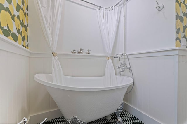 1579 Bayshore Blvd, Dunedin, FL 34698 - bathroom with a decorative wall, a freestanding bath, a wainscoted wall, and tile patterned flooring