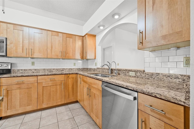 3512 Tealwood Cir, Palm Harbor, FL 34685 - kitchen with stainless steel appliances, light stone counters, tasteful backsplash, a textured ceiling, and recessed lighting
