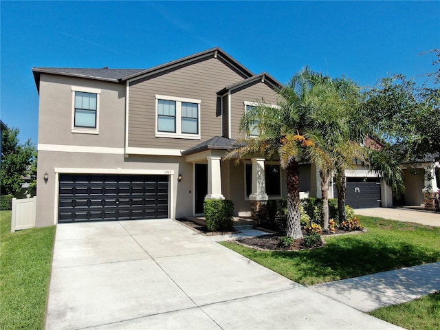 13903 Sage Thrasher Ln, Riverview, FL 33579 - view of front of property with driveway, stucco siding, a garage, and a front lawn