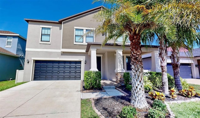 13903 Sage Thrasher Ln, Riverview, FL 33579 - view of front facade with stucco siding, driveway, a garage, and a porch
