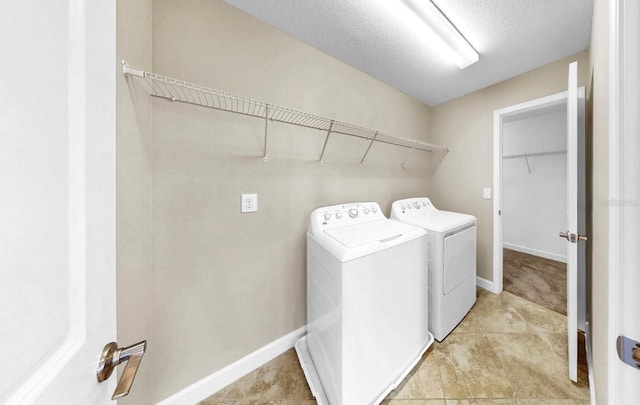 13903 Sage Thrasher Ln, Riverview, FL 33579 - washroom with washer and clothes dryer and a textured ceiling