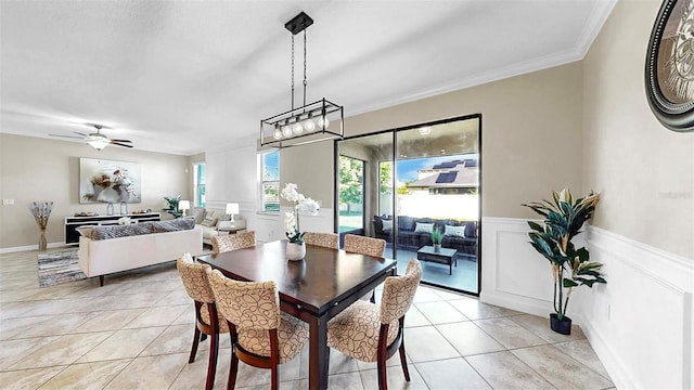 13903 Sage Thrasher Ln, Riverview, FL 33579 - dining space featuring light tile patterned floors, ornamental molding, a wainscoted wall, and a ceiling fan