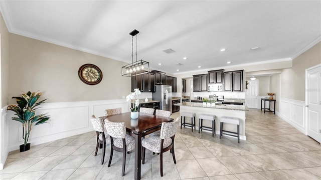13903 Sage Thrasher Ln, Riverview, FL 33579 - dining area with crown molding, light tile patterned floors, a decorative wall, wainscoting, and recessed lighting