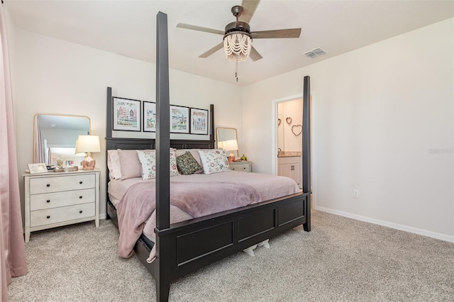 13958 Richland Gulf Cir, Parrish, FL 34219 - carpeted bedroom with baseboards, ensuite bath, and a ceiling fan