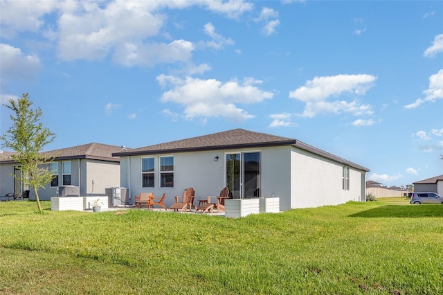 13958 Richland Gulf Cir, Parrish, FL 34219 - back of house featuring stucco siding, a lawn, and central AC unit