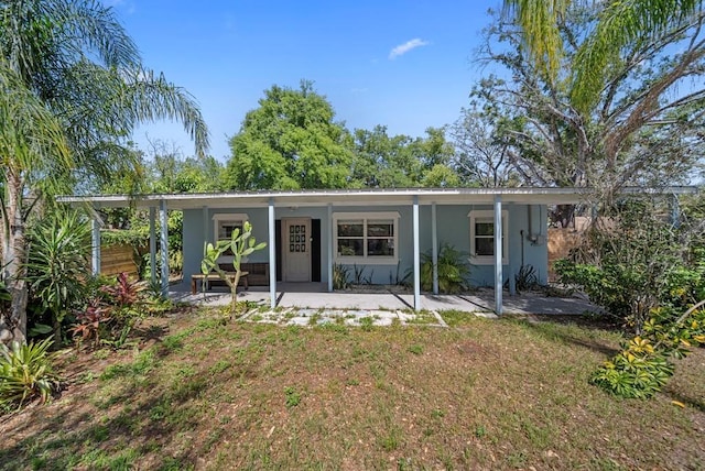 12304 Woodleigh Ave, Tampa, FL 33612 - rear view of house featuring a porch and stucco siding