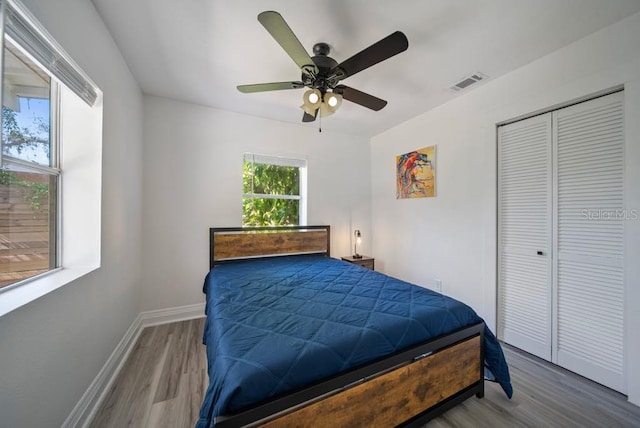 12304 Woodleigh Ave, Tampa, FL 33612 - bedroom with wood finished floors, baseboards, a closet, and a ceiling fan