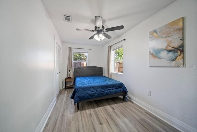 12304 Woodleigh Ave, Tampa, FL 33612 - bedroom featuring baseboards, light wood-style flooring, and a ceiling fan