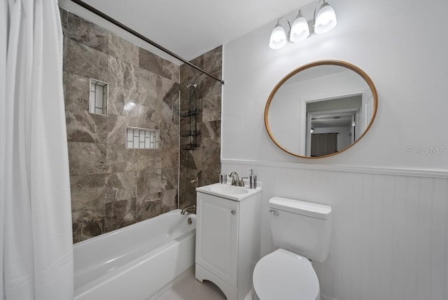 12304 Woodleigh Ave, Tampa, FL 33612 - full bath with shower / tub combo, a wainscoted wall, vanity, and toilet