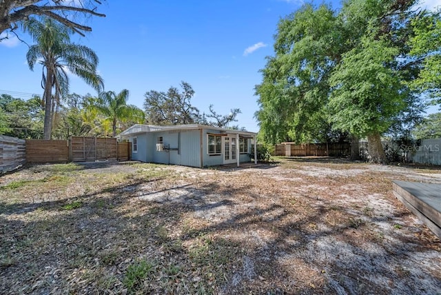 12304 Woodleigh Ave, Tampa, FL 33612 - rear view of house featuring a fenced backyard