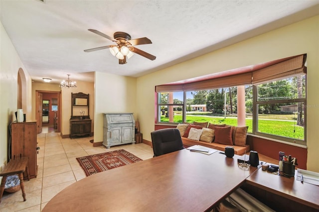 7507 Beasley Rd, Tampa, FL 33615 - office area with light tile patterned floors, a ceiling fan, a chandelier, arched walkways, and baseboards