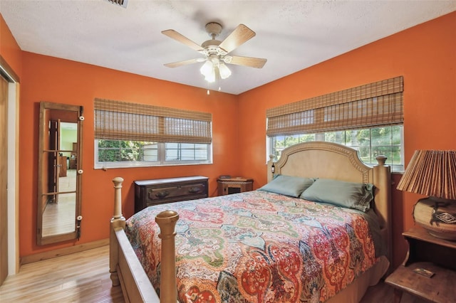 7507 Beasley Rd, Tampa, FL 33615 - bedroom featuring wood finished floors, multiple windows, and a ceiling fan
