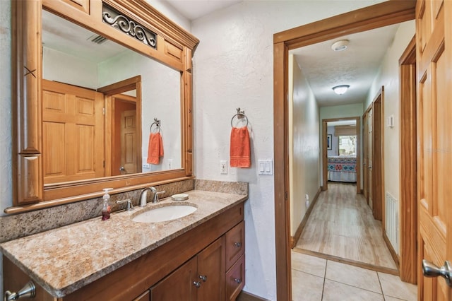 7507 Beasley Rd, Tampa, FL 33615 - bathroom featuring vanity, a textured wall, and tile patterned floors
