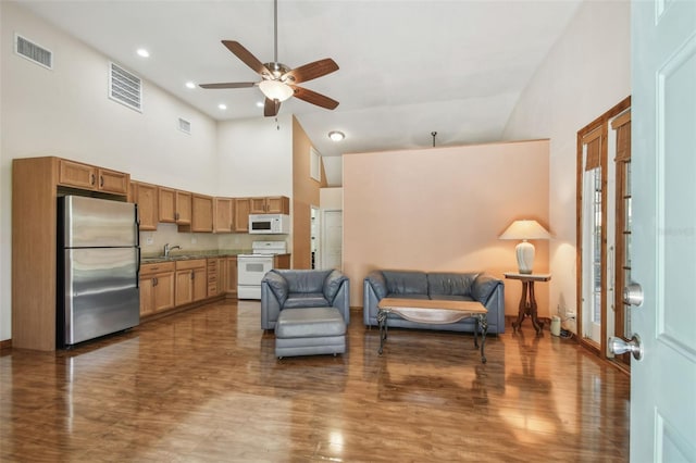 7507 Beasley Rd, Tampa, FL 33615 - living area with high vaulted ceiling, a ceiling fan, wood finished floors, and recessed lighting