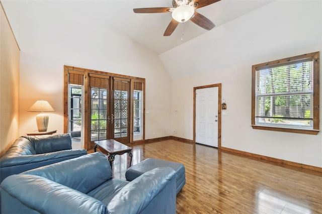 7507 Beasley Rd, Tampa, FL 33615 - living room featuring french doors, vaulted ceiling, wood finished floors, baseboards, and ceiling fan