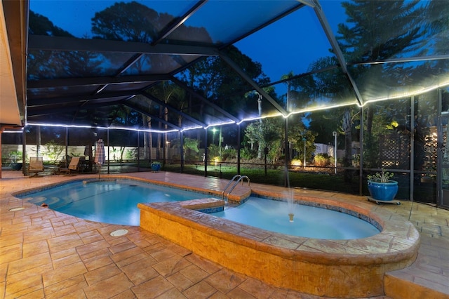7507 Beasley Rd, Tampa, FL 33615 - pool at night with a patio, a lanai, and a pool with connected hot tub