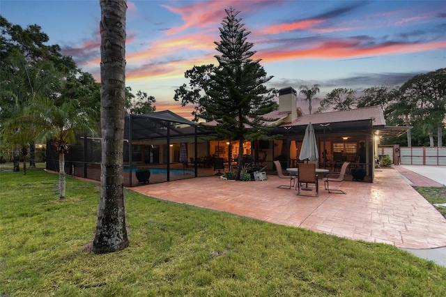 7507 Beasley Rd, Tampa, FL 33615 - back of house with a patio, a chimney, an outdoor pool, and metal roof
