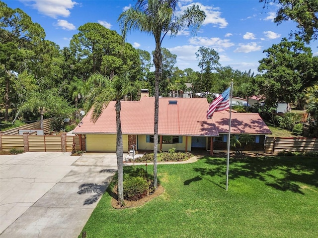 7507 Beasley Rd, Tampa, FL 33615 - view of front of house featuring a tiled roof, driveway, a garage, stucco siding, and view of wooded area