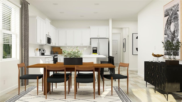 12597 Lily Quartz Loop, Parrish, FL 34219 - dining area with light wood-style floors and baseboards