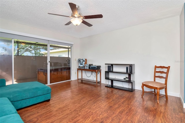 2444 Laurelwood Dr Unit A, Clearwater, FL 33763 - living area featuring wood finished floors, a textured ceiling, and a ceiling fan