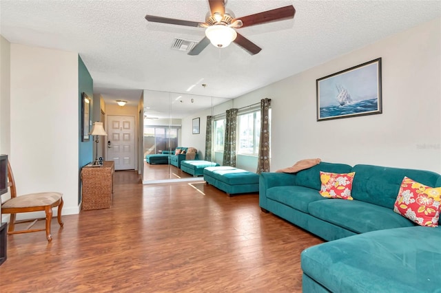 2444 Laurelwood Dr Unit A, Clearwater, FL 33763 - living area featuring wood finished floors, a textured ceiling, and ceiling fan