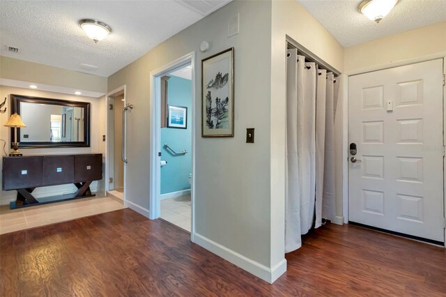2444 Laurelwood Dr Unit A, Clearwater, FL 33763 - entryway featuring a textured ceiling, baseboards, and wood finished floors