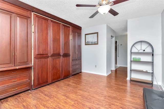 2444 Laurelwood Dr Unit A, Clearwater, FL 33763 - unfurnished bedroom with light wood-style floors, baseboards, and a textured ceiling