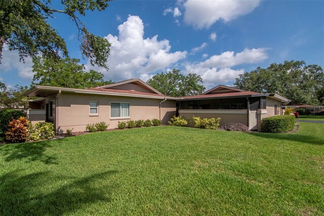 2444 Laurelwood Dr Unit A, Clearwater, FL 33763 - view of front of property featuring a front yard and stucco siding