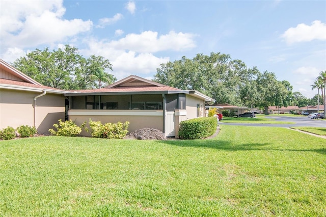 2444 Laurelwood Dr Unit A, Clearwater, FL 33763 - view of side of property with a yard and stucco siding