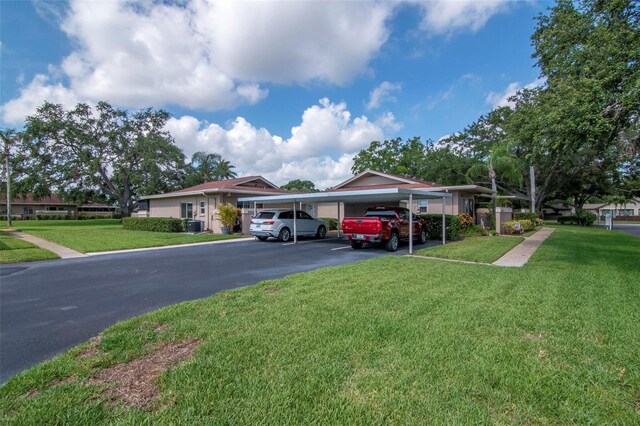 2444 Laurelwood Dr Unit A, Clearwater, FL 33763 - view of front of property with a front lawn, a carport, and driveway