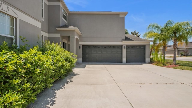 3862 Tristram Loop, Land O Lakes, FL 34638 - view of home's exterior with stucco siding, driveway, and a garage