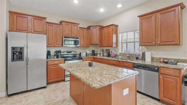 3862 Tristram Loop, Land O Lakes, FL 34638 - kitchen featuring appliances with stainless steel finishes, a sink, a center island, light stone counters, and recessed lighting