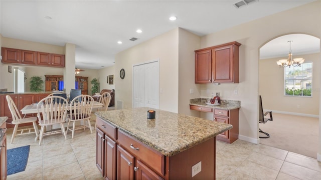3862 Tristram Loop, Land O Lakes, FL 34638 - kitchen with a chandelier, arched walkways, light stone counters, a kitchen island, and recessed lighting