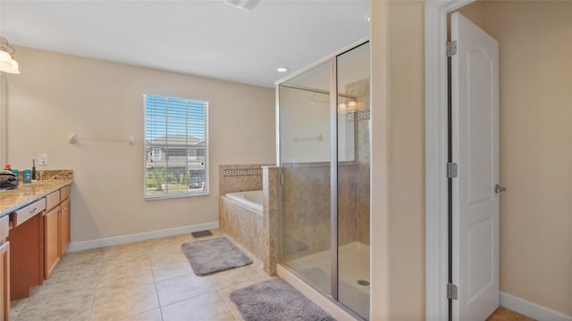 3862 Tristram Loop, Land O Lakes, FL 34638 - bathroom with vanity, a bath, a shower stall, baseboards, and tile patterned floors